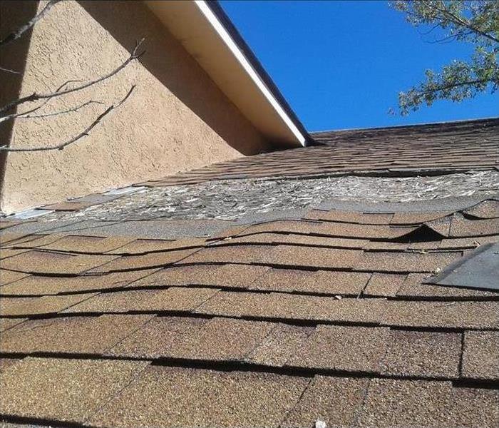 Roof shingles warped and bent