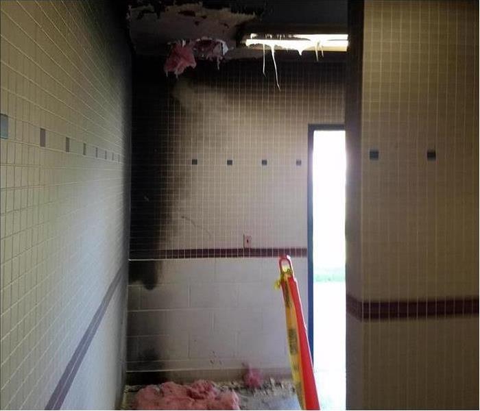 School bathroom wall showing lots of soot and fire damage