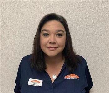 Female employee smiling in front of white back ground